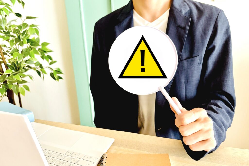 注意の札を持っている男性の画像