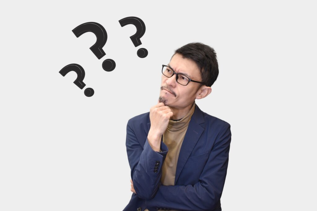 頭を抱えるビジネスマンの画像